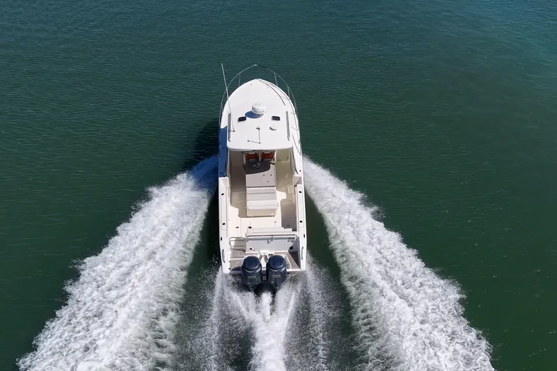 Slide: The Image of 2006 Pursuit 345 Drummond Runner LS boat cruising on open water. - 33