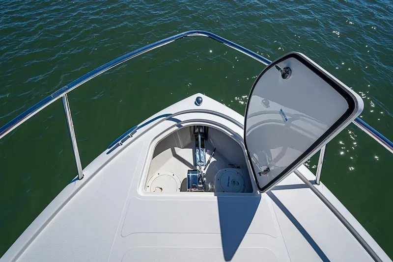 Slide: The Image of Bow of 2006 Pursuit 345 Drummond Runner LS with open anchor hatch on water. - 6