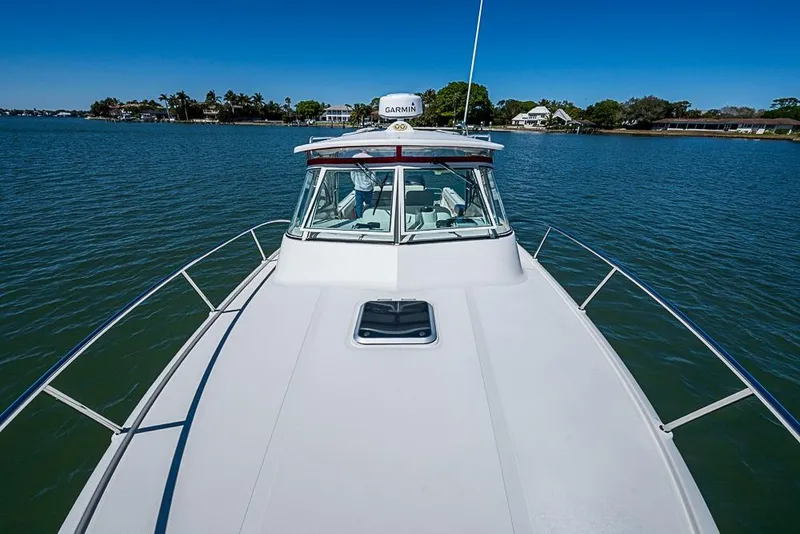 Slide: The Image of 2006 Pursuit 345 Drummond Runner LS boat on calm water, clear sky background. - 7