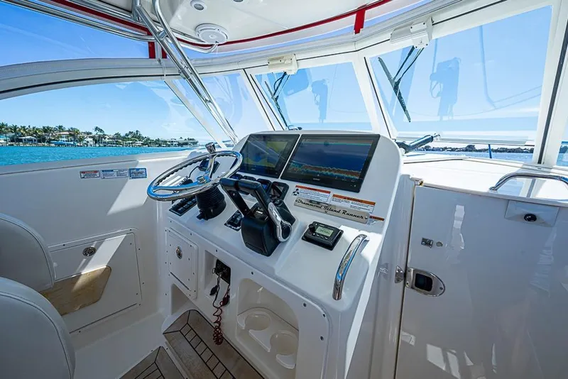 Slide: The Image of Helm of 2006 Pursuit 345 Drummond Runner LS with dual screens and steering wheel. - 8