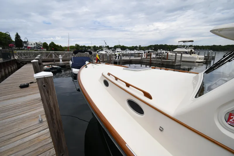 Slide: The Image of 2005 Hinckley Picnic Boat 36 EP docked at a marina under cloudy skies. - 4