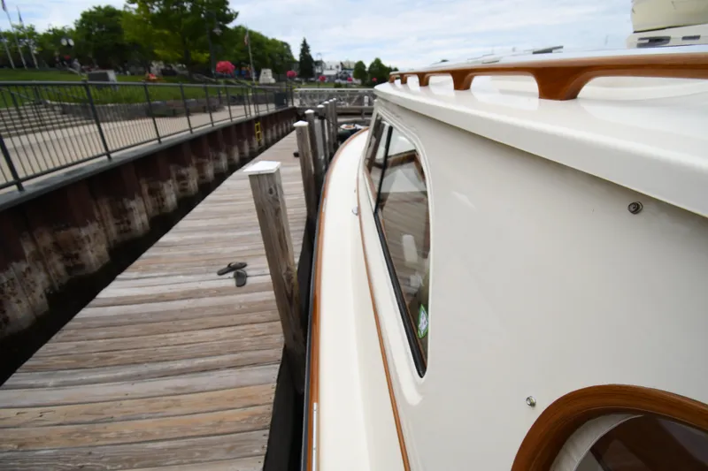 Slide: The Image of 2005 Hinckley Picnic Boat 36 EP docked at a wooden pier. - 6