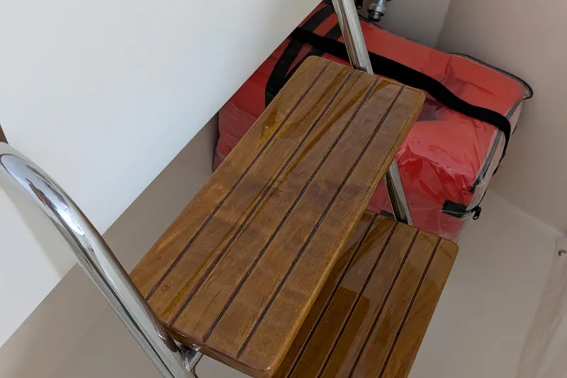 Slide: The Image of Wooden steps and a red life jacket on a 2005 Hinckley Picnic Boat 36 Classic EP. - 10