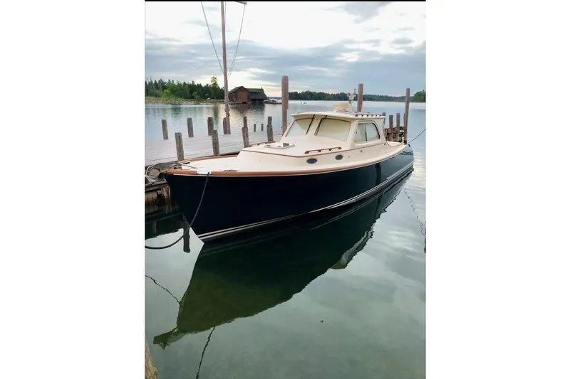 Slide: The Image of 2005 Hinckley Picnic Boat 36 Classic EP docked on calm water. - 12