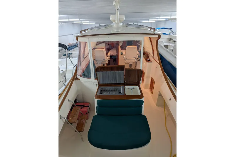 Slide: The Image of Interior view of a Hinckley Picnic Boat with seating area and helm station. - 13