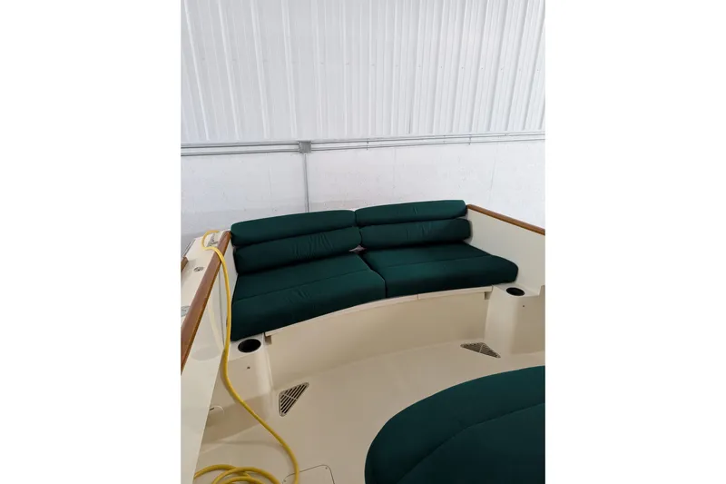 Slide: The Image of 2005 Hinckley Picnic Boat 36 EP interior with green cushioned seating. - 17