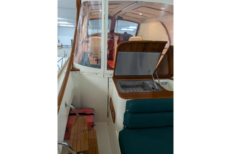 Slide: The Image of 2005 Hinckley Picnic Boat 36 EP interior with seating and grill area. - 19