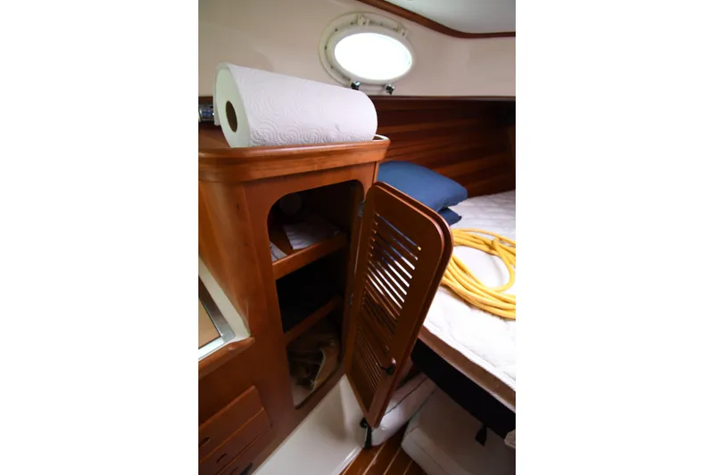 Slide: The Image of Interior of 2005 Hinckley Picnic Boat 36 EP with wooden cabinet and bed. - 28