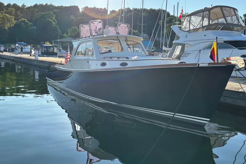 Slide: The Image of 2005 Hinckley Picnic Boat 36 Classic EP docked in a serene marina setting. - 2