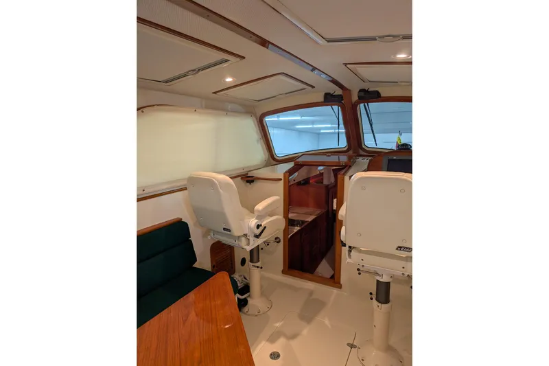 Slide: The Image of Interior of 2005 Hinckley Picnic Boat 36 EP with helm seats and wooden accents. - 22