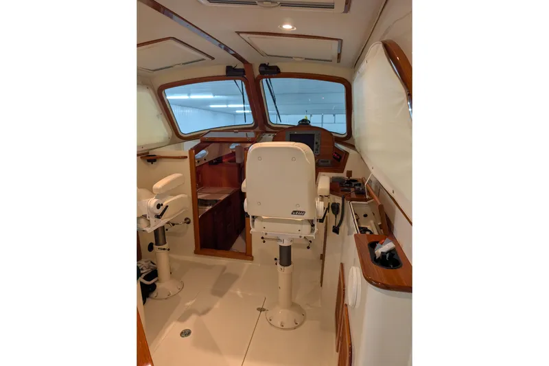Slide: The Image of Interior of 2005 Hinckley Picnic Boat 36 EP, featuring helm station and seating. - 23