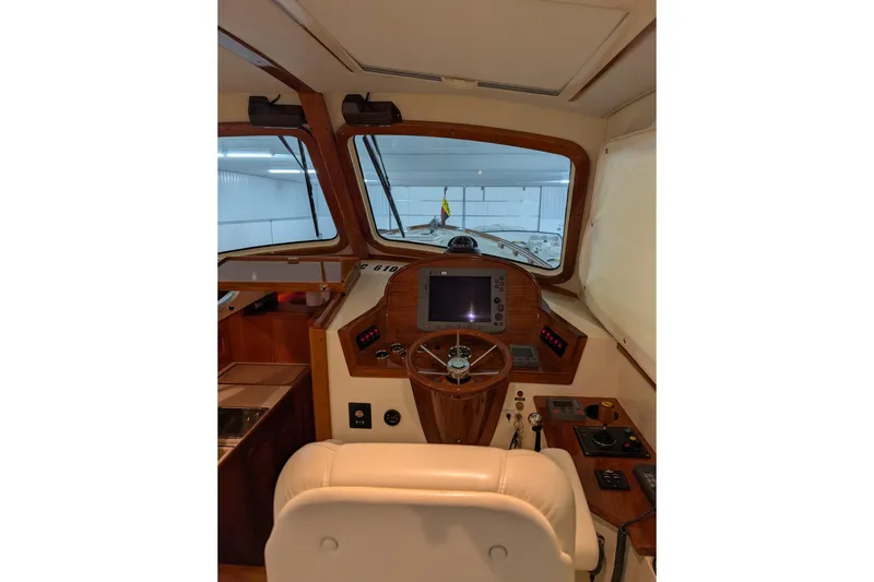 Slide: The Image of Interior helm of 2005 Hinckley Picnic Boat 36 EP with navigation controls. - 24