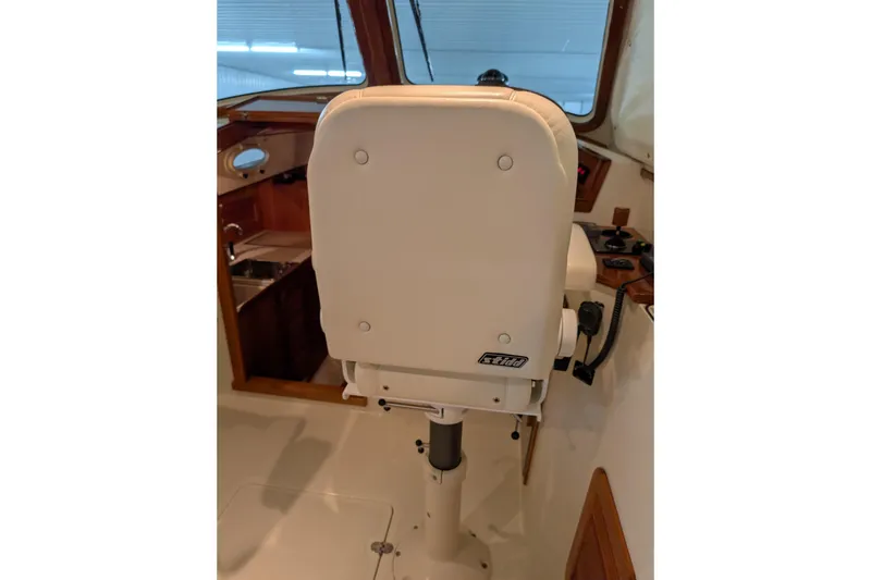 Slide: The Image of Captain's chair on 2005 Hinckley Picnic Boat 36 EP, showcasing helm area and controls. - 32