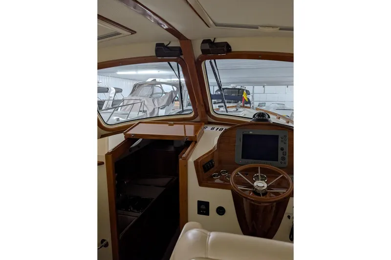 Slide: The Image of 2005 Hinckley Picnic Boat 36 Classic EP interior with wooden helm and navigation equipment. - 33