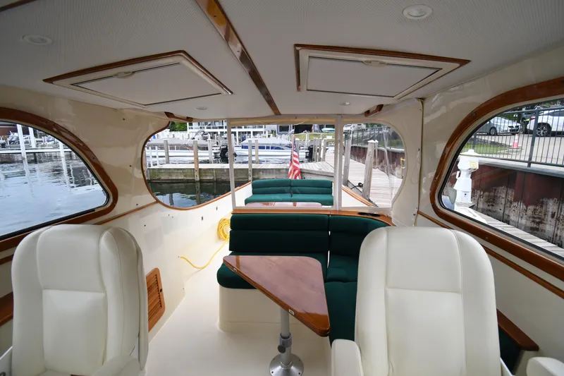 Slide: The Image of Interior of a 2005 Hinckley Picnic Boat 36 EP with elegant seating and wooden accents. - 18