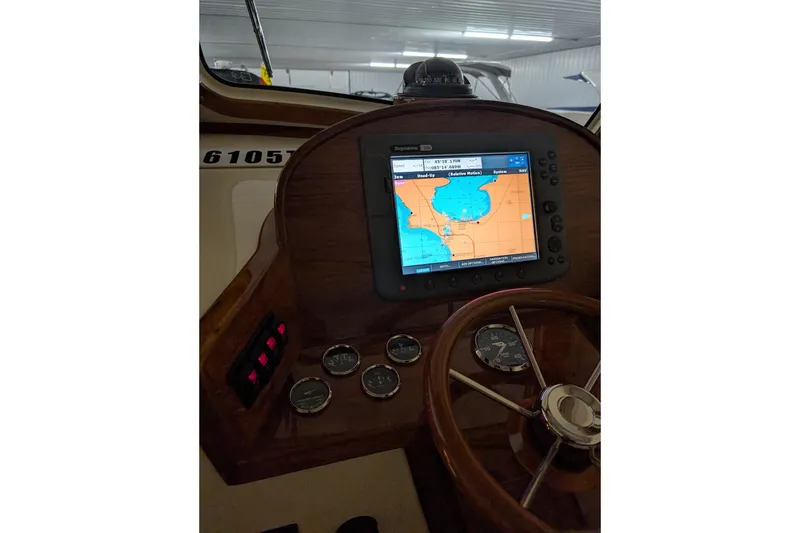 Slide: The Image of Helm of 2005 Hinckley Picnic Boat 36 Classic EP with navigation display and gauges. - 34