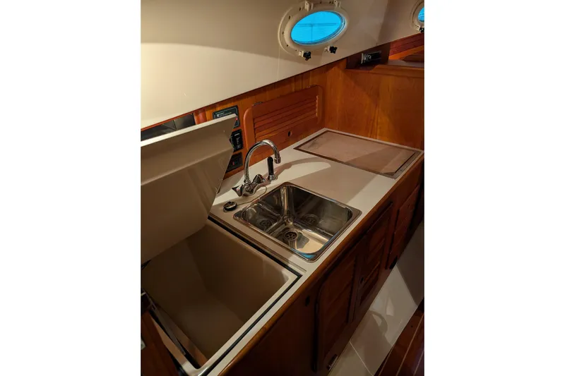 Slide: The Image of 2005 Hinckley Picnic Boat 36 EP galley with sink and storage. - 39