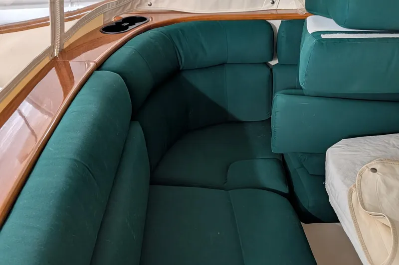 Slide: The Image of 2005 Hinckley Picnic Boat 36 Classic EP interior with green cushioned seating. - 4