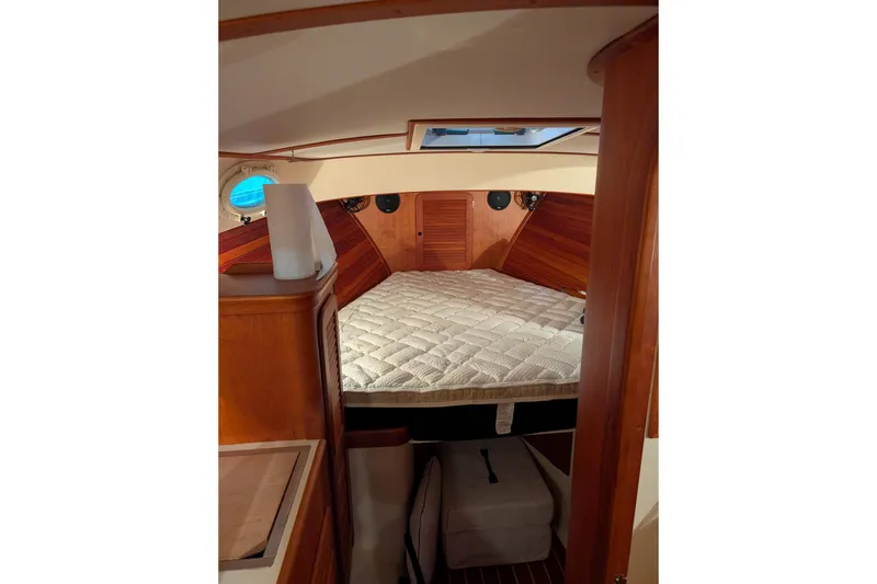 Slide: The Image of Interior cabin of 2005 Hinckley Picnic Boat 36 EP with cozy bed and wooden finish. - 40