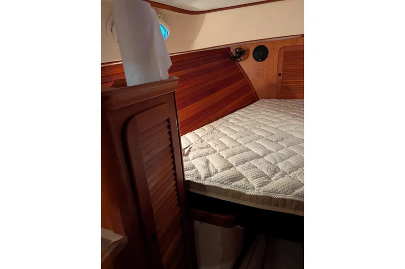Slide: The Image of Cozy cabin interior of 2005 Hinckley Picnic Boat 36 EP with wooden paneling and mattress. - 42