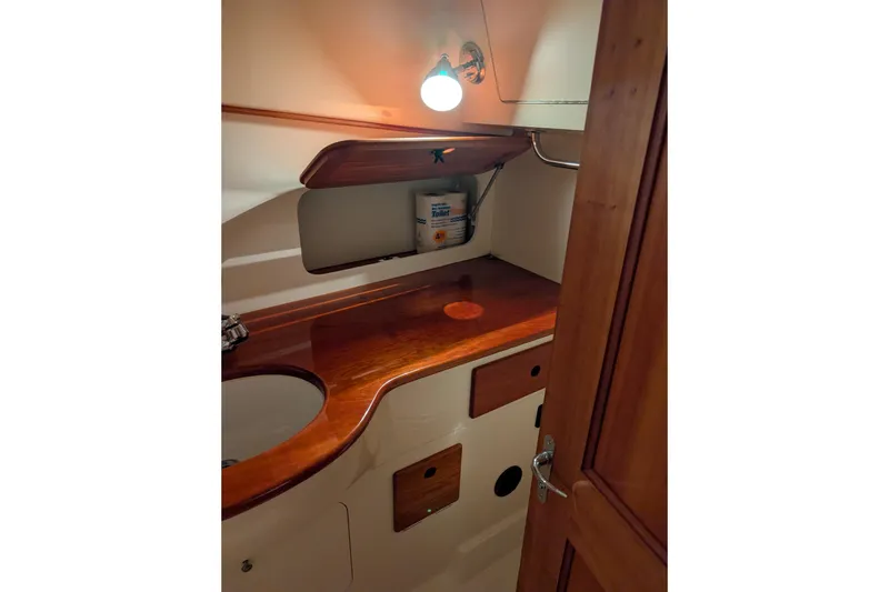 Slide: The Image of 2005 Hinckley Picnic Boat 36 EP interior with wooden cabinetry and sink area. - 43