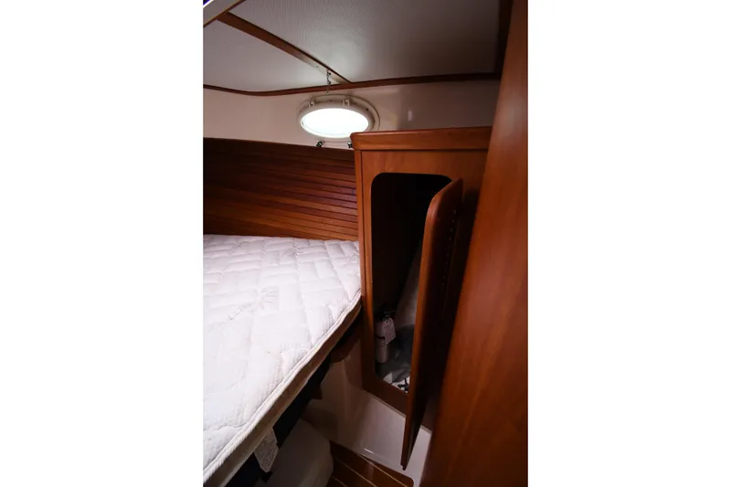 Slide: The Image of Interior cabin of 2005 Hinckley Picnic Boat 36 EP with wooden paneling and bed. - 29