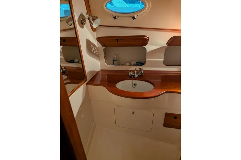 Slide: The Image of Elegant bathroom interior of 2005 Hinckley Picnic Boat 36 EP with wooden accents. - 44