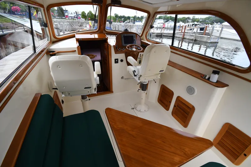 Slide: The Image of Interior of 2005 Hinckley Picnic Boat 36 EP with helm and seating area. - 17