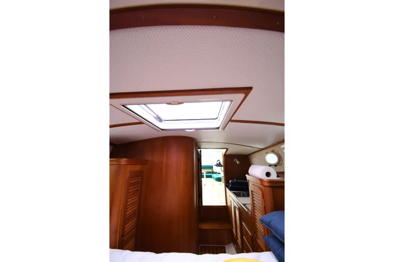 Slide: The Image of Interior of 2005 Hinckley Picnic Boat 36 EP with wooden cabinetry and skylight. - 30