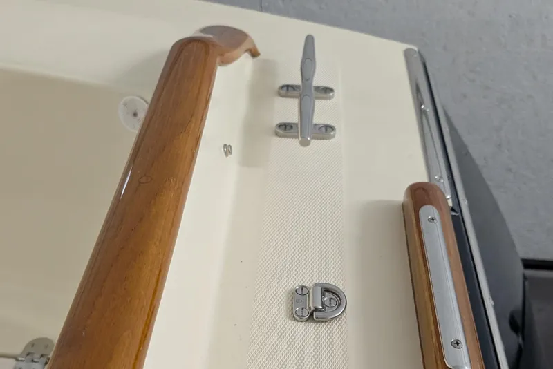 Slide: The Image of 2005 Hinckley Picnic Boat 36 Classic EP deck with wooden handrails and metal fittings. - 9