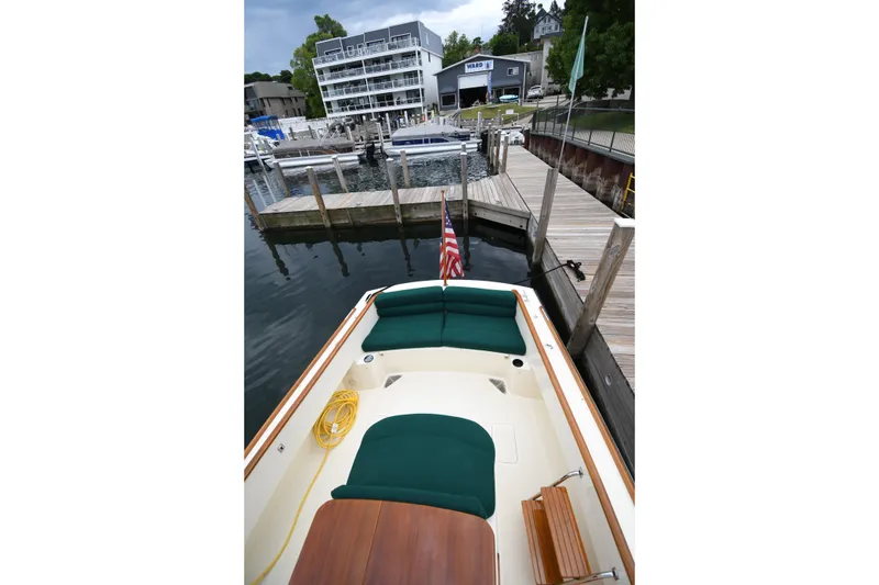 Slide: The Image of 2005 Hinckley Picnic Boat 36 EP docked at a marina with green seating. - 14
