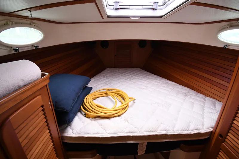 Slide: The Image of Cozy cabin interior of 2005 Hinckley Picnic Boat 36 EP with bed and portholes. - 27