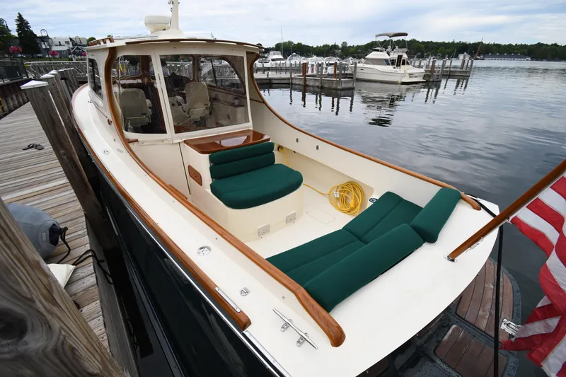 Slide: The Image of 2005 Hinckley Picnic Boat 36 EP docked, featuring green seating and wooden accents. - 11