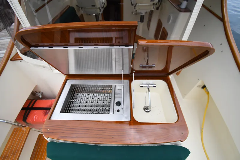 Slide: The Image of Outdoor kitchen setup on a 2005 Hinckley Picnic Boat 36 EP, featuring a grill and sink. - 13
