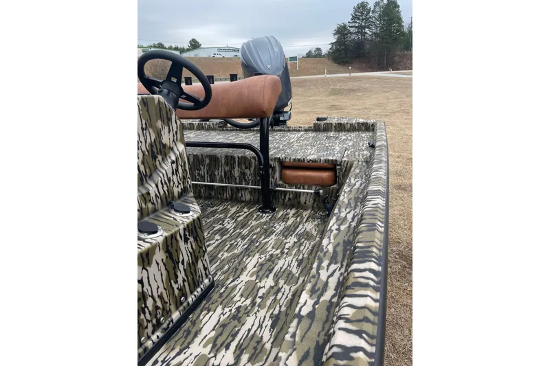 Slide: The Image of 2026 Avid 20 Rogue CC boat with camouflage design and brown seating. - 3