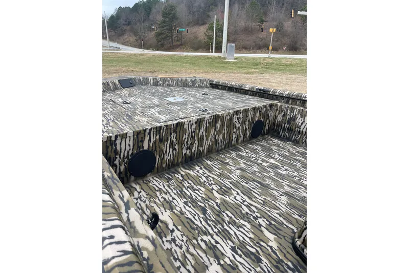 Slide: The Image of Camouflage interior of 2026 Avid 20 Rogue CC boat, parked outdoors. - 6