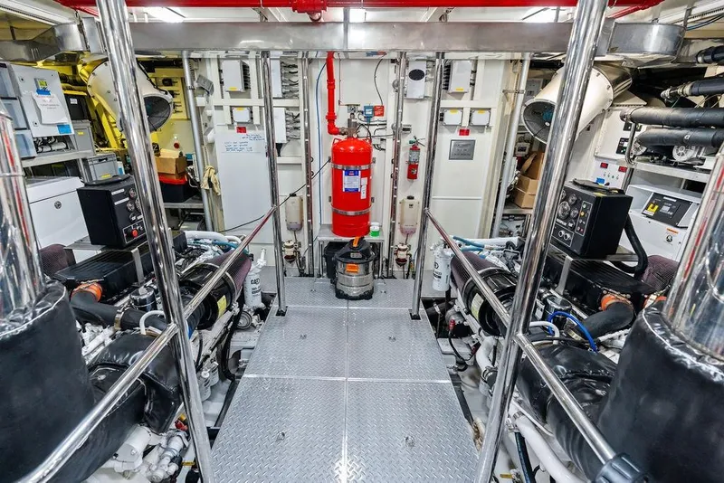 Slide: The Image of Engine room of 2014 Horizon RP 110 yacht, featuring machinery and safety equipment. - 104