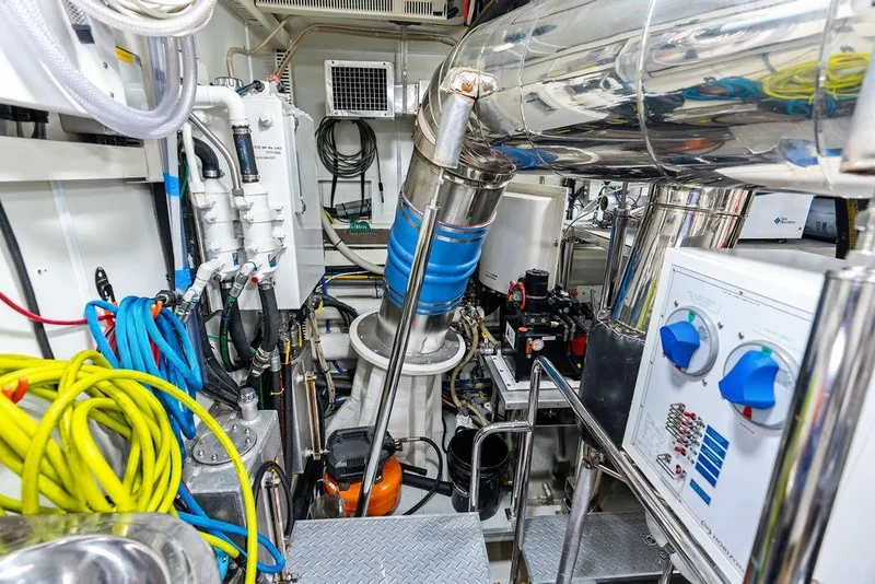 Slide: The Image of Engine room of 2014 Horizon RP 110 yacht with cables, pipes, and control panels. - 105