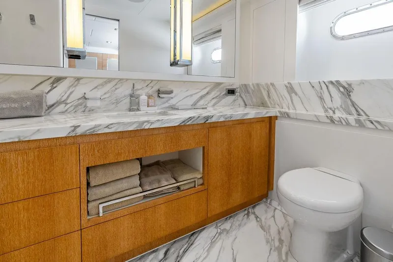 Slide: The Image of Luxurious yacht bathroom with marble countertops, wooden cabinetry, and modern fixtures, Horizon RP 110, 2014. - 46
