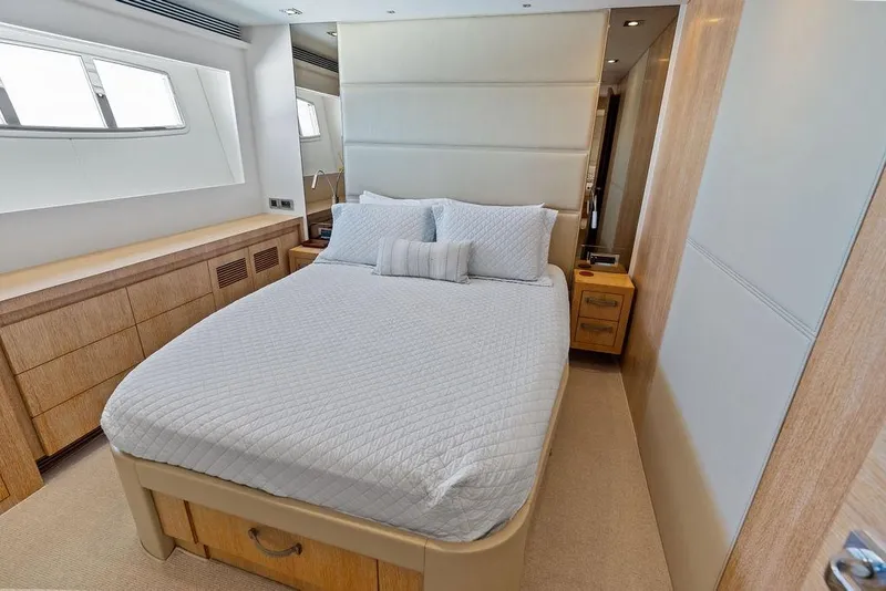 Slide: The Image of Luxurious bedroom interior on 2014 Horizon RP 110 yacht, featuring elegant bedding and wood accents. - 52