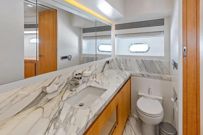 Slide: The Image of Luxurious yacht bathroom with marble countertop, modern fixtures, and porthole window on Horizon RP 110, 2014. - 62