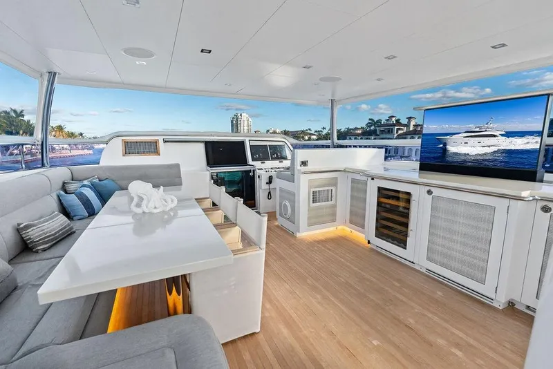 Slide: The Image of Luxurious Horizon RP 110 yacht interior with modern seating, TV, and ocean view, 2014 model. - 73