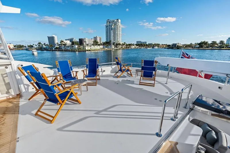 Slide: The Image of Spacious deck of 2014 Horizon RP 110 yacht with blue chairs, overlooking waterfront cityscape. - 79