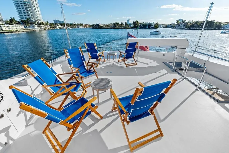 Slide: The Image of Deck of 2014 Horizon RP 110 yacht with blue chairs overlooking water. - 80