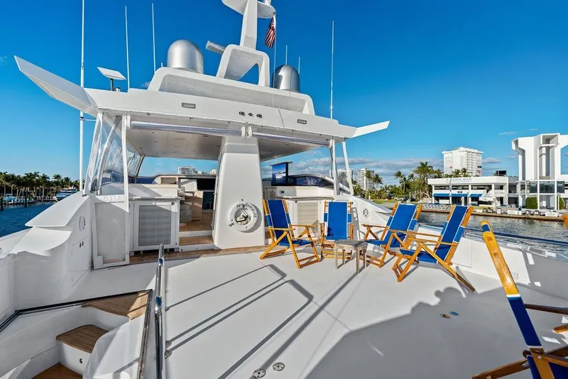 Slide: The Image of Luxurious 2014 Horizon RP 110 yacht deck with blue chairs, docked in a sunny marina. - 81