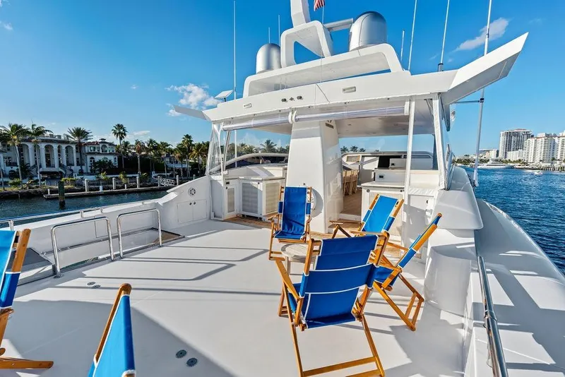 Slide: The Image of Luxurious Horizon RP 110 yacht deck with blue chairs, sunny waterfront view, 2014 model. - 82