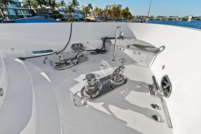 Slide: The Image of Deck of 2014 Horizon RP 110 yacht with winches and seating, docked by palm trees. - 84