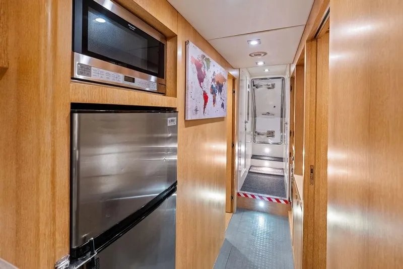 Slide: The Image of Hallway in 2014 Horizon RP 110 yacht with stainless steel appliances and world map artwork. - 93