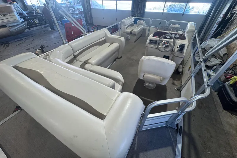 Slide: The Image of 2008 Sun Tracker Party Barge 200 Classic Series interior with white seating and steering console. - 15