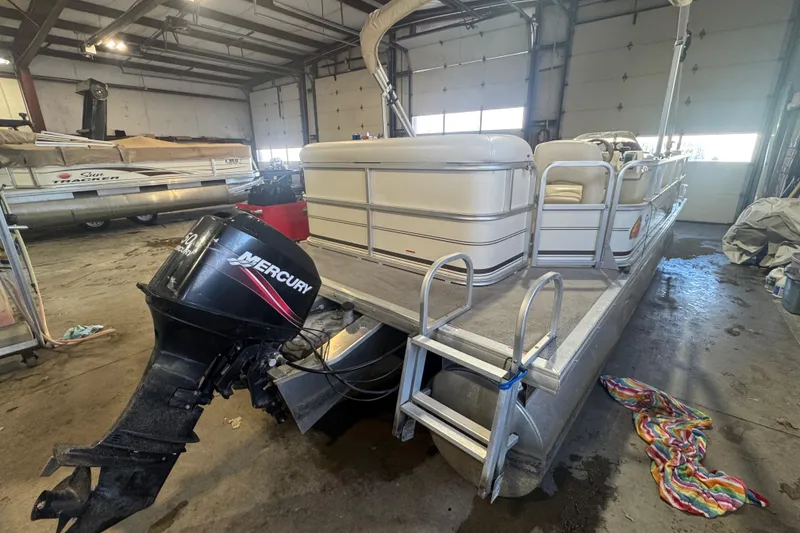 Slide: The Image of 2008 Sun Tracker Party Barge 200 Classic Series pontoon boat with Mercury outboard motor in a garage. - 4
